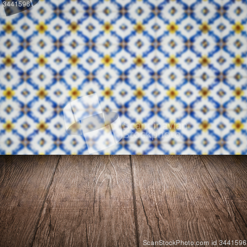 Image of Wood table top and blur vintage ceramic tile pattern wall