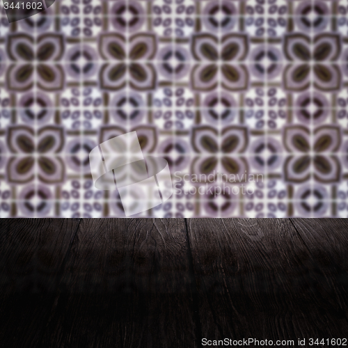 Image of Wood table top and blur vintage ceramic tile pattern wall