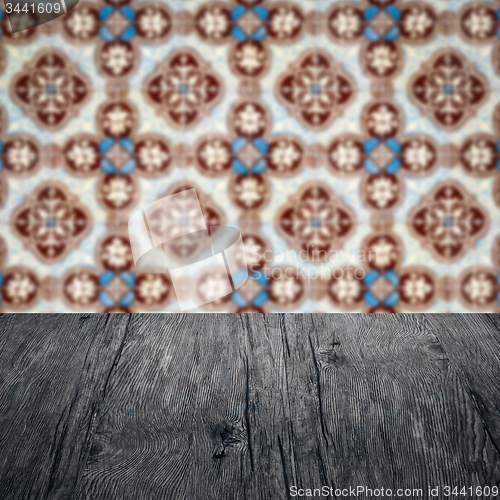 Image of Wood table top and blur vintage ceramic tile pattern wall