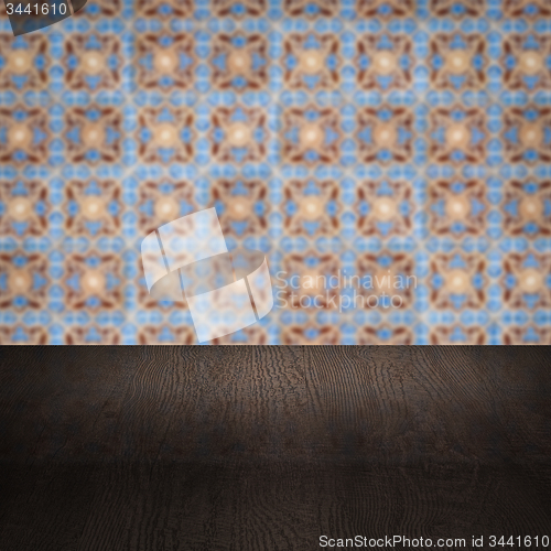 Image of Wood table top and blur vintage ceramic tile pattern wall