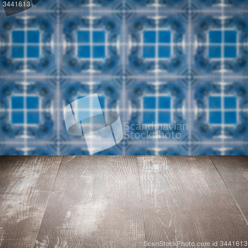 Image of Wood table top and blur vintage ceramic tile pattern wall