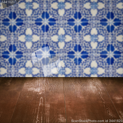 Image of Wood table top and blur vintage ceramic tile pattern wall