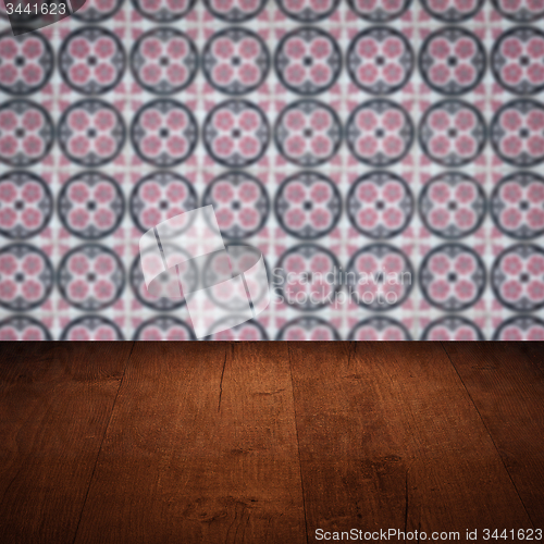 Image of Wood table top and blur vintage ceramic tile pattern wall