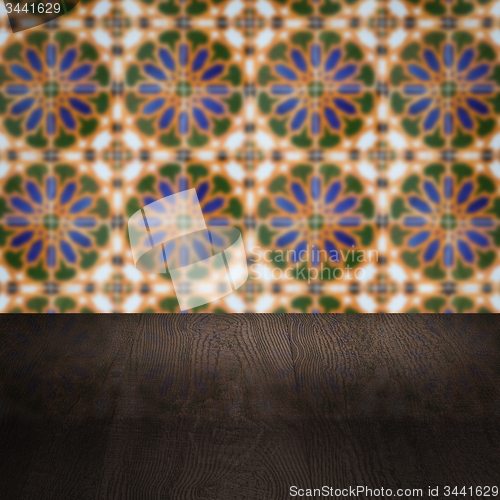 Image of Wood table top and blur vintage ceramic tile pattern wall