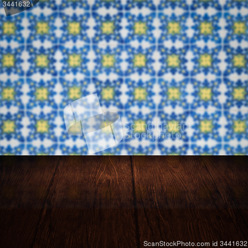 Image of Wood table top and blur vintage ceramic tile pattern wall