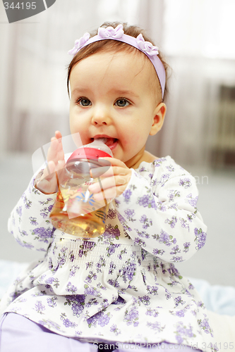 Image of Cute baby is drinking tea