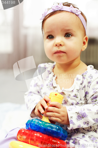 Image of Baby plays with toys