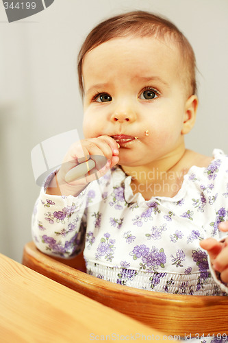 Image of Small cute baby eating