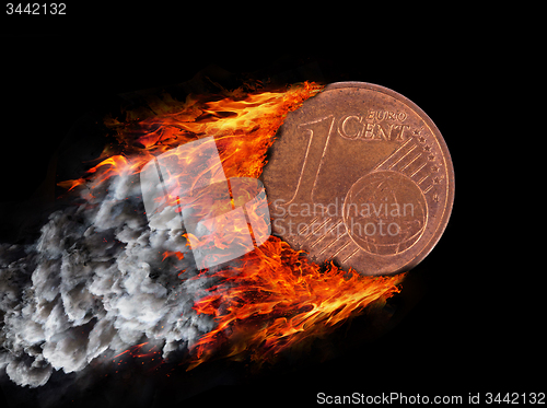 Image of Burning coin with a trail of fire and smoke