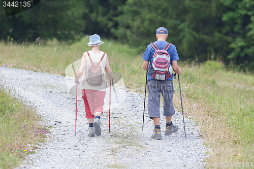 Image of Senior tourist couple hiking at the beautiful mountains
