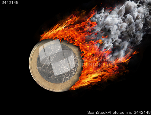 Image of Burning coin with a trail of fire and smoke