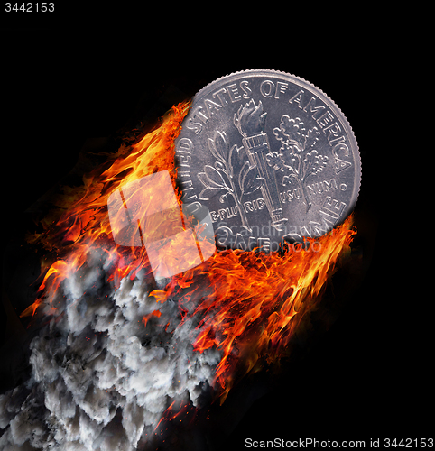 Image of Burning coin with a trail of fire and smoke