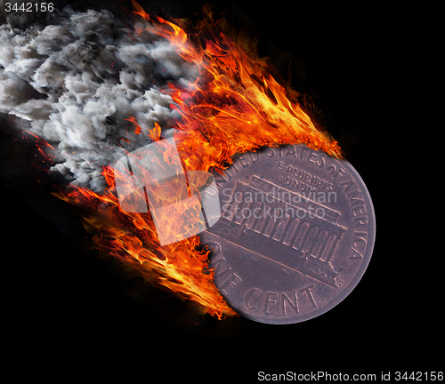 Image of Burning coin with a trail of fire and smoke