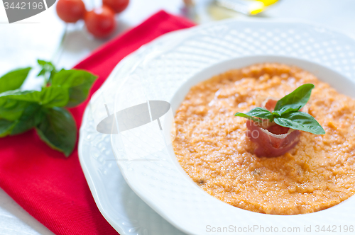 Image of Tomato soup with bread , garlic , oil , salt and pepper