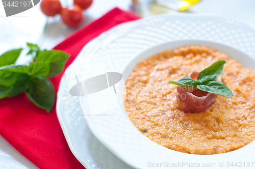 Image of Tomato soup with bread , garlic , oil , salt and pepper