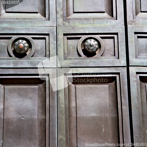 Image of in london antique brown door  rusty  brass nail and light