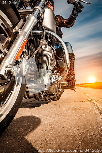 Image of Biker girl riding on a motorcycle