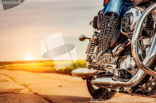 Image of Biker girl riding on a motorcycle