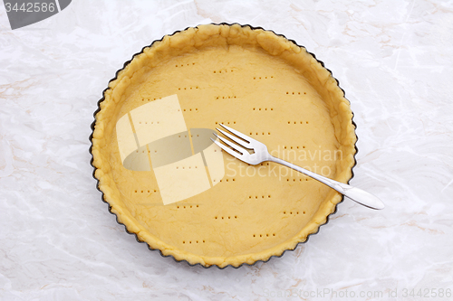 Image of Fork rests in a pricked pastry pie crust