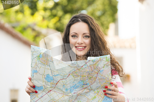 Image of Beautiful tourist searching on the map