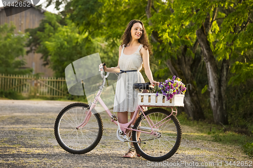 Image of Happy girl with her bicycle