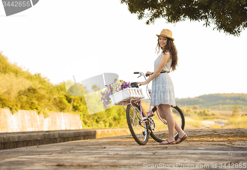 Image of Happy girl with her bicycle