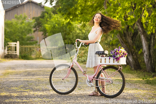 Image of Happy girl with her bicycle