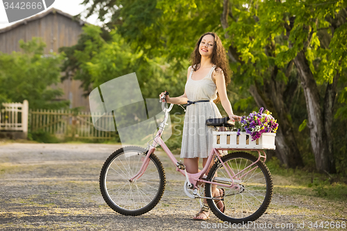 Image of Happy girl with her bicycle