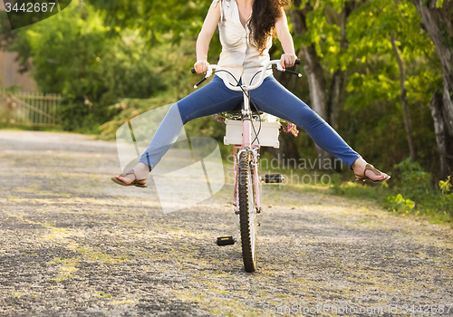 Image of Happy girl with her bicycle