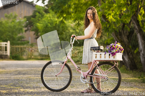 Image of Happy girl with her bicycle