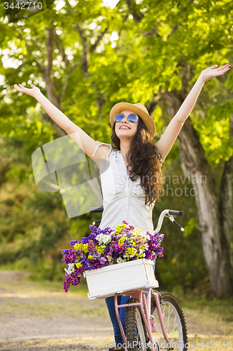 Image of Happy girl with her bicycle