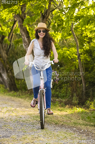 Image of Happy girl with her bicycle