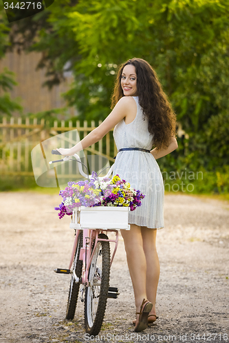 Image of Happy girl with her bicycle