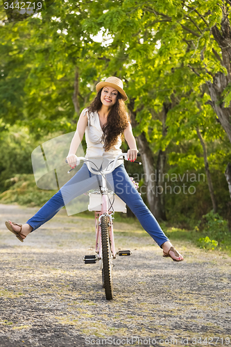 Image of Happy girl with her bicycle