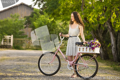 Image of Happy girl with her bicycle