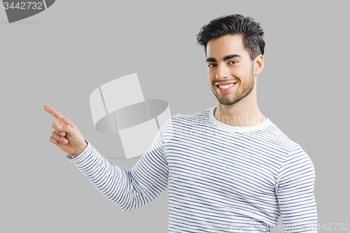 Image of Handsome young man pointing