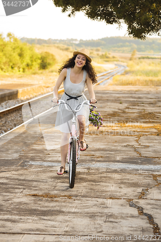 Image of Happy girl with her bicycle