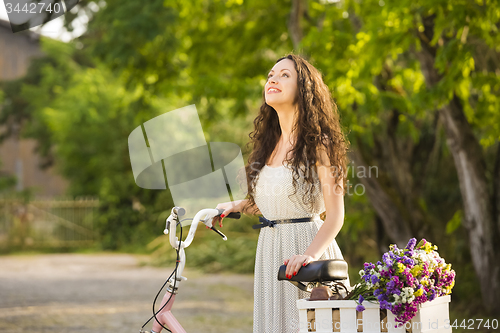 Image of Happy girl with her bicycle