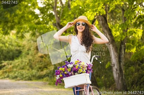 Image of Happy girl with her bicycle