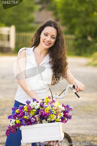 Image of Happy girl with her bicycle