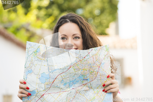 Image of Beautiful tourist searching on the map
