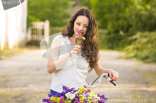 Image of Happy girl with her bicycle