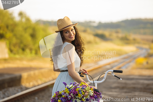 Image of Happy girl with her bicycle