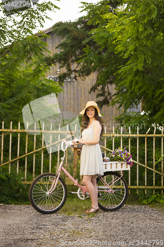 Image of Happy girl with her bicycle