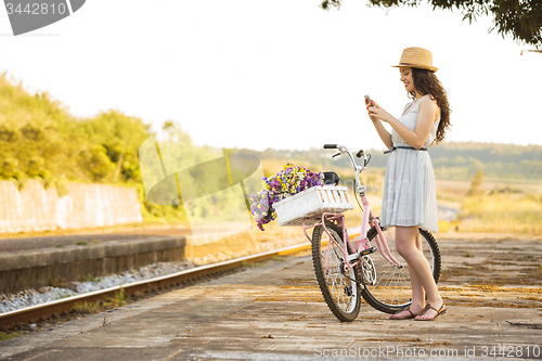 Image of Happy girl with her bicycle