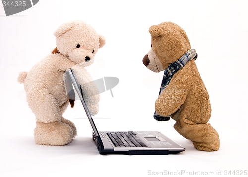 Image of Laptop and teddy bear