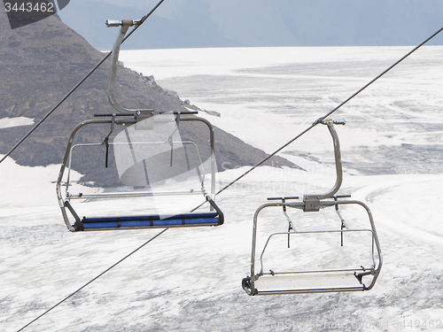 Image of Empty ski lift above snow