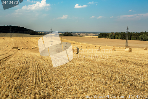 Image of Beautiful landscape with straw bales in harvested fields