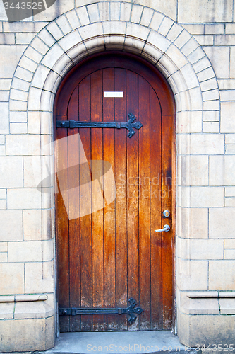 Image of wooden parliament in door and marble antique  wall