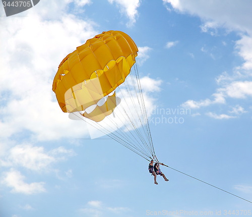 Image of Parasailing in a blue sky near sea beach